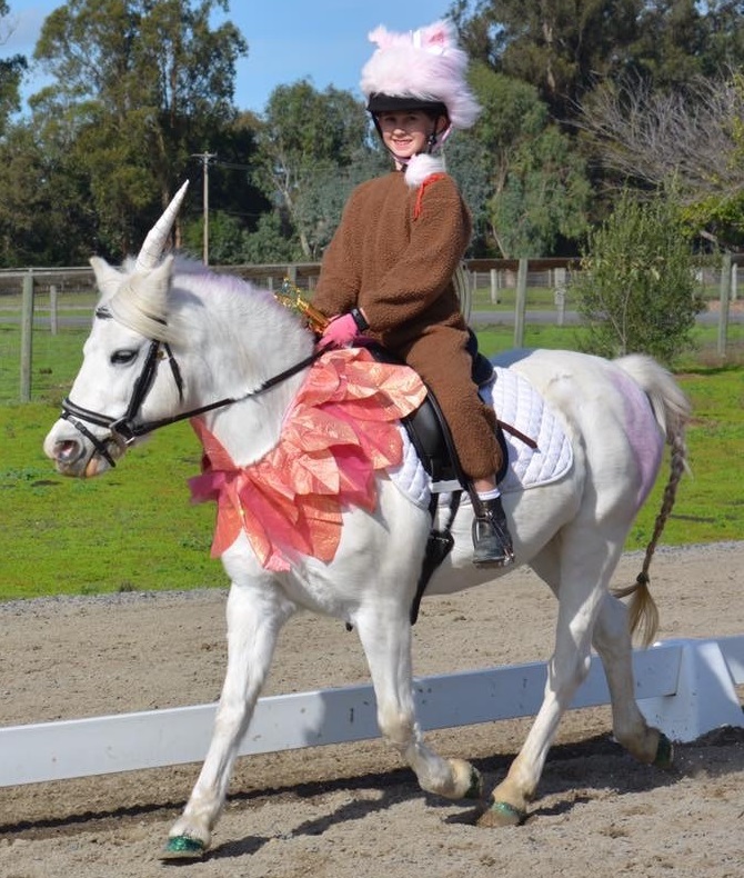 Gwen and her owner dressed up in a unicorn costume